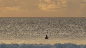 Young surfer silhouette sitting on his surfboard in the ocean water at sunrise. beautiful seascape at morning time.Maldives - Powered by Shutterstock - Get 15% off with code: PIKWIZARD15