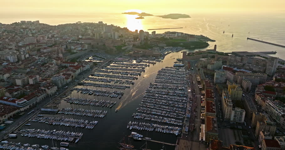 Many boats and yachts are parked in the city marina. Aerial view of the port of Marseille in the morning sun. Drone view of Marseille in the south of France