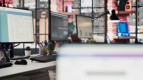 Multiple computer monitors in empty office displaying analytics dashboards and data charts. Office workspace with screens showing digital data visualization and operational management - Powered by Shutterstock - Get 15% off with code: PIKWIZARD15