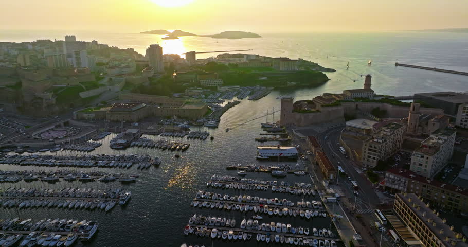 Many boats and yachts are parked in the city marina. Aerial view of the port of Marseille in the morning sun. Drone view of Marseille in the south of France