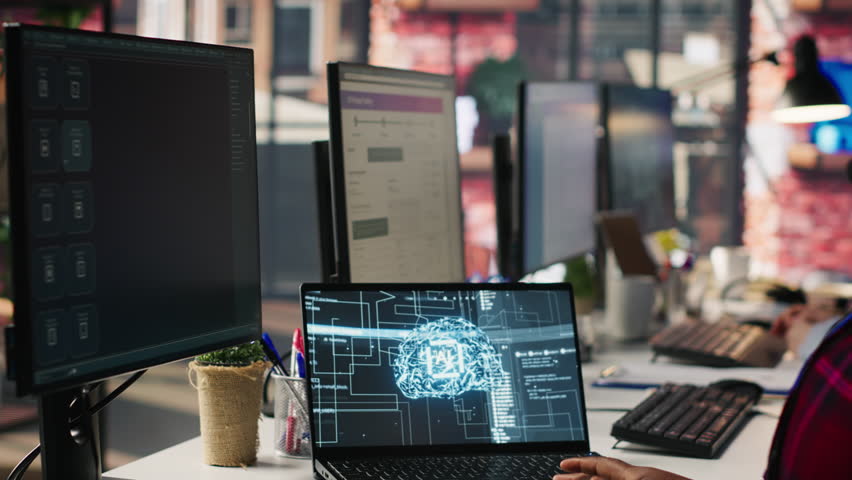 Call center employee using AI chatbot at office desk to reply to common customer queries, close up. Customer service staff member at work generates automated responses to clients using AI, camera A