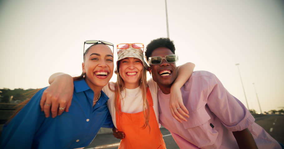 Outdoor, hug and face of people for fashion, streetwear and stylish clothes for summer break. Friends, women and man with laughing for connection, gen z and bonding in portrait by New York bridge