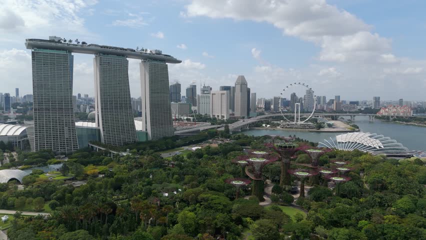 Iconic aerial view of Marina Bay Sands landmark overlooking Gardens by The Bay in Singapore.