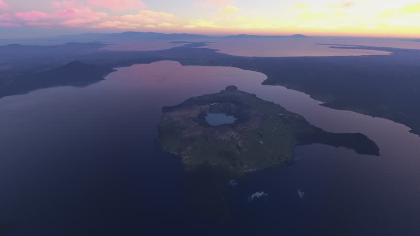 3D - Top aerial drone view at dusk of Taal Volcano and Vulcan Point in Volcano Island. Philippines