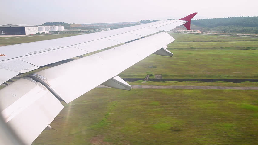 Landing aircraft. The view from the airplane window. Airport Kuala Lumpur, Malaysia