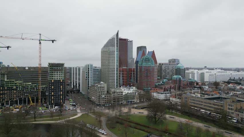 Aerial view of The Hague’s city center featuring iconic skyscrapers, modern architecture, and urban atmosphere on a cloudy day.