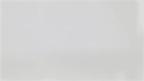 Macro video captures popcorn kernels falling in slow motion against a neutral background, highlighting texture and movement - Powered by Shutterstock - Get 15% off with code: PIKWIZARD15