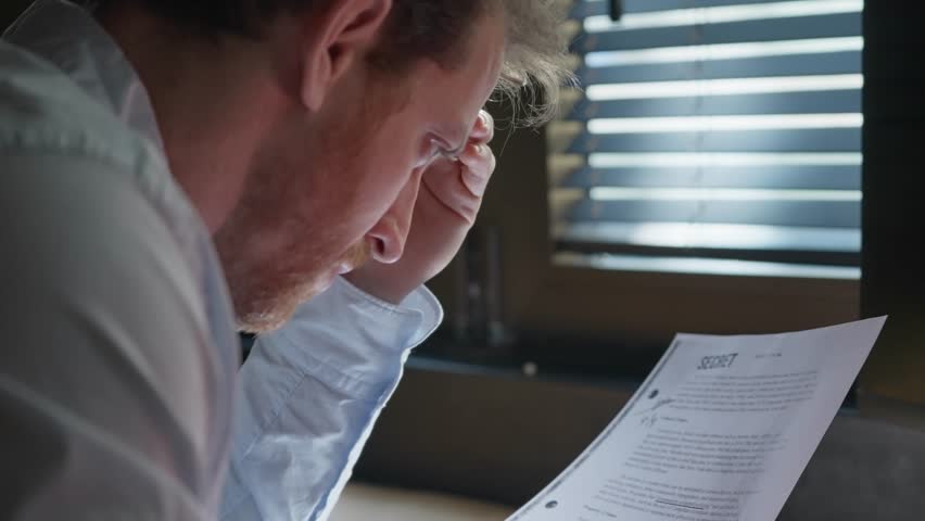 Businessman, agent, or investigator reviewing a secret file, marking key details with a red marker. Over-the-shoulder shot. Investigation, intelligence, classified information, or corporate intrigue.