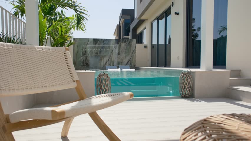 A small private swimming pool in the backyard of a luxury villa in Dubai on a sunny day