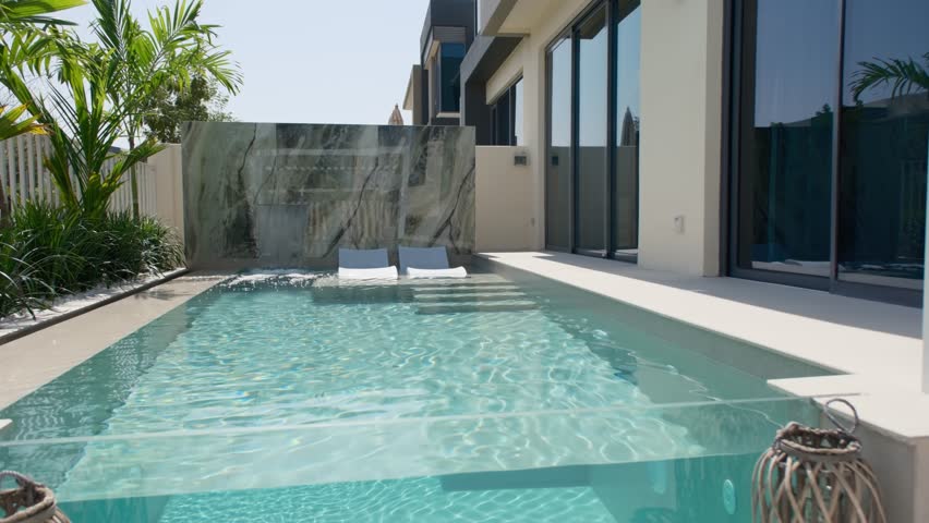 A small private swimming pool in the backyard of a luxury villa in Dubai on a sunny day