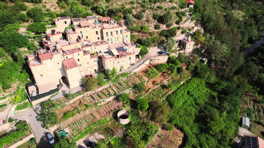 Mountainside Medieval Town In The Countryside Of Italy, bordering France. Torri Superiore renovated old town village Aerial drone Shot