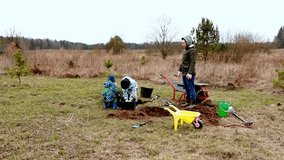 Children and adult gardening together in a field, planting flowers and enjoying nature - Powered by Shutterstock - Get 15% off with code: PIKWIZARD15