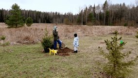 Planting trees together in a community effort during a chilly day in a forested area - Powered by Shutterstock - Get 15% off with code: PIKWIZARD15