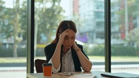Young businesswoman feeling tired and stressed from working with a laptop computer, having a headache and holding her head in her hands while sitting at her desk - Powered by Shutterstock - Get 15% off with code: PIKWIZARD15