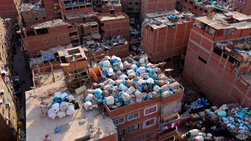 Pile Of Garbage Dumped On The Rooftop Of Building In Manshiyat Naser, Cairo, Egypt. - aerial shot