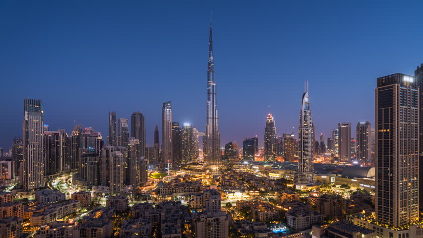 Timelapse of view of sunrise over the Burj Khalifa and other towers in Downtown Dubai, United Arab Emirates (UAE), modern cities and skylines, business and finance concept, zooming in. 