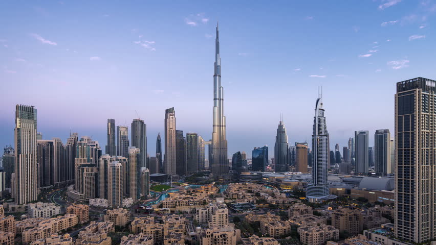 Timelapse of view of sunrise over the Burj Khalifa and other towers in Downtown Dubai, United Arab Emirates (UAE), modern cities and skylines, business and finance concept, zooming in. 