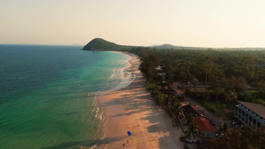 Drone Establishing Aerial fly pristine white sand, blue sea beach of Chumphon Thailand landcape, travel destination in southeast asia