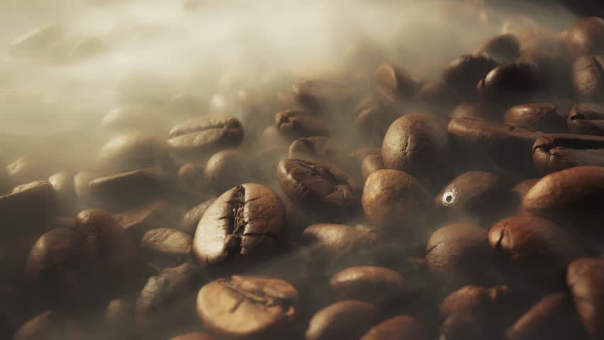 Sliding shot of roast coffee beans with smoke on dark background. Fresh coffee beans roasting with aromatic steam rising in a warm and cozy setting during the morning coffee ritual 