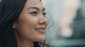 Woman captured in a profile view with a joyful smile and gentle windswept hair. The outdoor setting adds a natural and candid atmosphere to her expression of happiness. - Powered by Shutterstock - Get 15% off with code: PIKWIZARD15