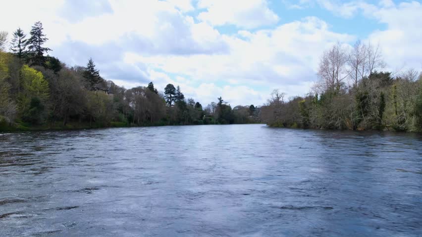 Scenic view of River Ness swollen with fast flowing water after heavy rain in Scottish city of Inverness, Scotland UK