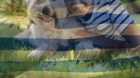 Smiling boy with dog, Uruguay flag overlay, creating animation in school setting. Childhood, pet, creativity, classroom, education, joyful - Powered by Shutterstock - Get 15% off with code: PIKWIZARD15