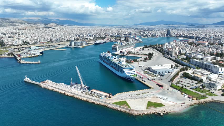 Aerial drone cinematic video of famous and busy port of Piraeus where passenger ships travel to popular Aegean destinations, Attica, Greece