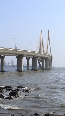 View of a Rajiv Gandhi Sea Link Bridge from the sea shore in Mumbai, India. Vertical motion video.