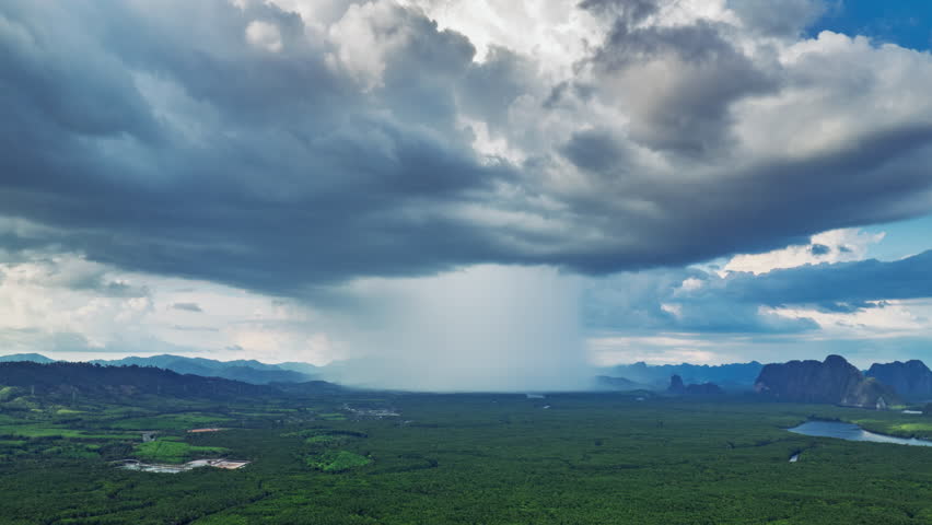 Hyperlase aerial drone shot of dark strom with rain pass over mangroove forest in Krabi, Thailand 
