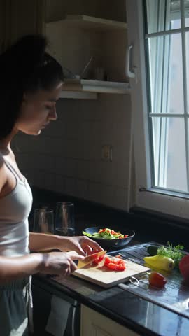 A Woman Skillfully Cooking Fresh and Colorful Vegetables in a Stylish Modern Kitchen Space