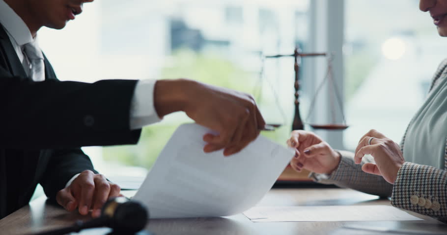 Hands, attorney and writing with documents in office, agreement and review for compliance at company. People, lawyer and paperwork with consultation, contract and signature at corporate law firm