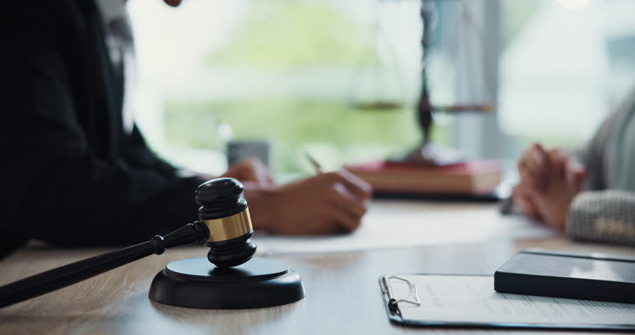 People, attorney and handshake with gavel in office, agreement and review for compliance at company. Advocate, client and documents with consultation, contract and signature at corporate law firm