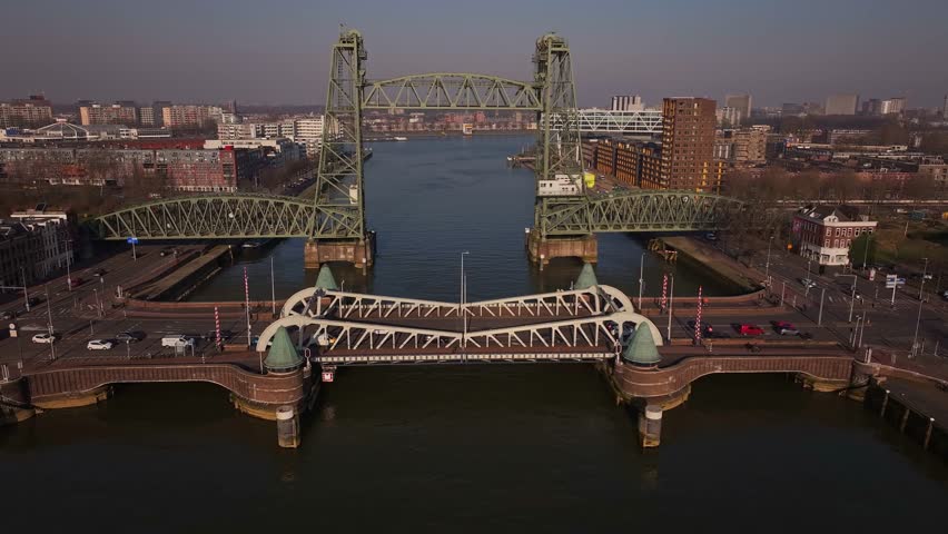 De Hef bridge lifting over water with cars passing underneath in Rotterdam, Netherlands
