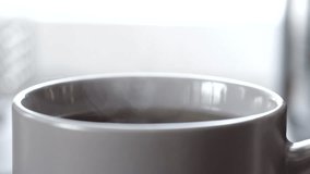 Lemon slice dropping into steaming tea in slow motion - Powered by Shutterstock - Get 15% off with code: PIKWIZARD15