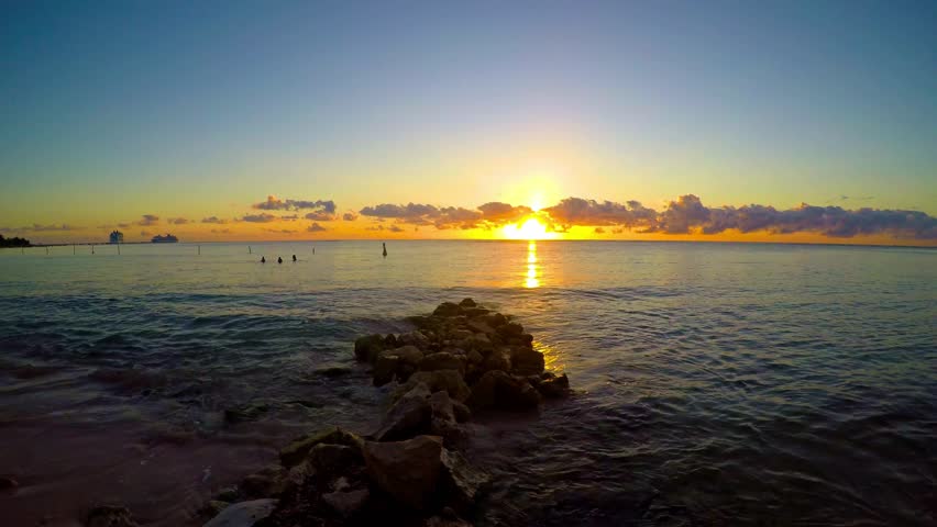 Stunning sunrise over the caribbean sea in mahahual, mexico, creating a breathtaking spectacle of color and light