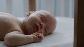 Close up, cute newborn baby sleeping sweetly in bed. Healthy sleep. Motherhood. Mother's day. Family. Birth of a child. Slow motion video 4K - Powered by Shutterstock - Get 15% off with code: PIKWIZARD15
