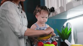 healthy food for kids, caring female parent peeling banana for little cute girl in kitchen - Powered by Shutterstock - Get 15% off with code: PIKWIZARD15