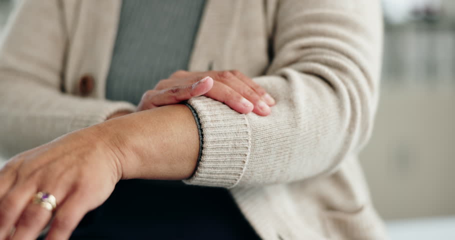 Old woman, arms and arthritis pain in home, massage joint and inflammation of bone disease. Senior person, sprain and swollen muscle by chronic fibromyalgia, hurt and osteoporosis or rheumatism