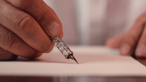 Close up old elderly man hands writing letter message write handwriting male holding using fountain pen aged person businessman business working writer senior grandfather indoors desk office document - Powered by Shutterstock - Get 15% off with code: PIKWIZARD15