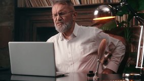 Old Caucasian man work laptop computer back pain health medicine suffer male pensioner elderly businessman office feel ache backache disease arthritis overwork spine osteoporosis business home problem - Powered by Shutterstock - Get 15% off with code: PIKWIZARD15