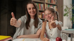Caucasian woman teacher tutor child little girl team school learning studying schoolgirl classroom showing thumbs up like approval recommend gesture education good lesson together pupil kid student - Powered by Shutterstock - Get 15% off with code: PIKWIZARD15