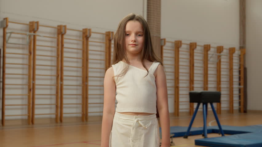 Little Caucasian girl with skipping rope child kid pupil schoolgirl sport lesson physical education training exercise acrobat gymnast school gym sportswoman teenager workout learner classroom student