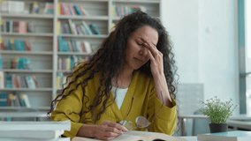 Arabian Latina woman tired exhausted female take off glasses rubbing eyes girl student library study learning eyestrain suffer bad vision university high school education touch nose books overworked - Powered by Shutterstock - Get 15% off with code: PIKWIZARD15
