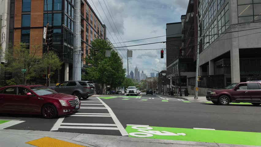 ATLANTA, GEORGIA - APRIL 4, 2025: The busy 14th Street NW and Howell Mill Rd NW intersection timelapse shows hustle and bustle of daily activity.