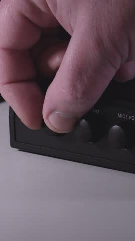 Turning on the sound device. Volume, echo, mic, simple sound effects. Karaoke set. Close-up- Vertical