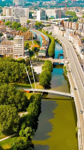 Vertical video. Ghent, Belgium. Keizerpark - City park. Esco (Scheldt) river embankment. Panorama of the city from the air. Cloudy weather, summer day, Aerial View, Departure of the camera. Rich colo