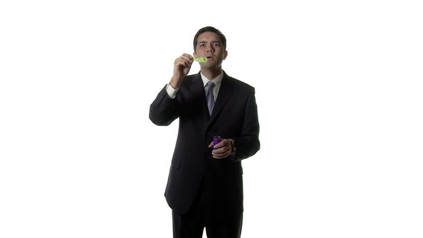 Businessman blowing soap bubbles, a metaphor for economic bubbles and sudden