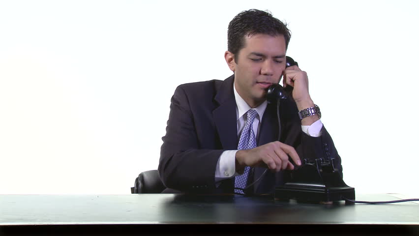 Business man in white studio on the phone, starting a phone call then talking on