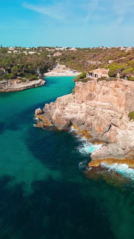 Aerial top down view of the Cala Llombards beach in Mallorca, Balearic Islands, Spain. Stunning Mediterranean Sea coast with turquoise water sea bay and white sand beach. Mallorca travel destinations