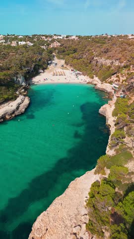 Aerial top down view of the Cala Llombards beach in Mallorca, Balearic Islands, Spain. Stunning Mediterranean Sea coast with turquoise water sea bay and white sand beach. Mallorca travel destinations